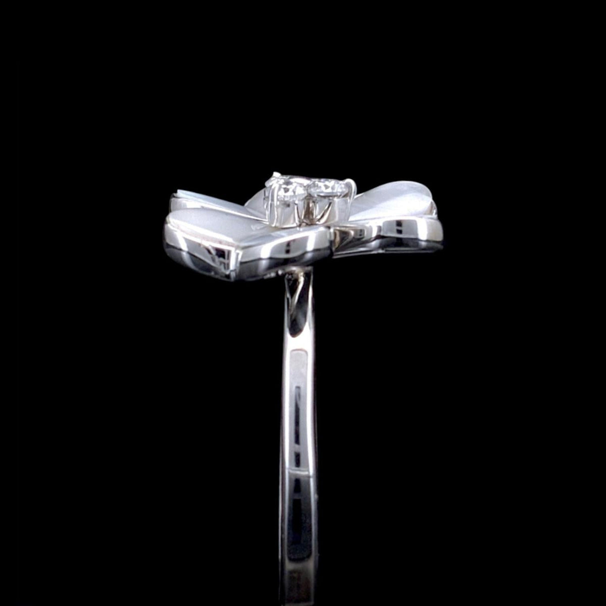 Impimo 0.15 CT moissanite and mother of pearl flower ring - side view with the flower head in profile and the plain band behind.