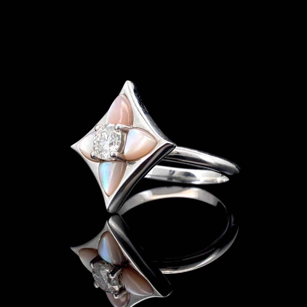 Impimo 0.50 CT moissanite and pink mother of pearl ring - angled view of the geometric frame with pink shell inlay and the moissanite centre.