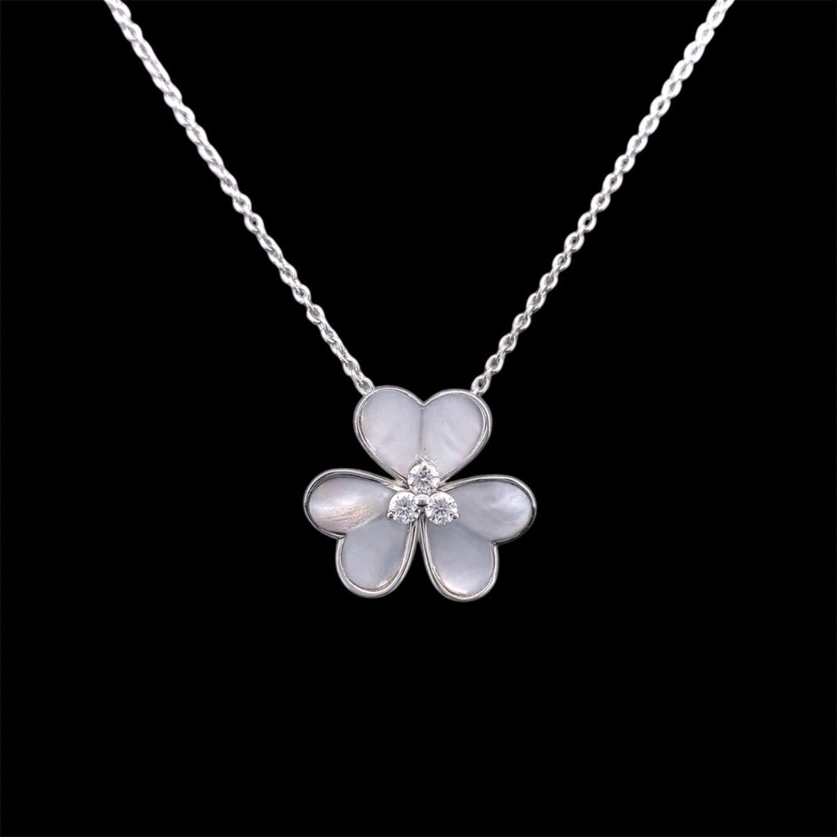 Impimo mother of pearl and moissanite flower pendant necklace, 925 sterling silver with 18K white gold plating - the full chain shown with the shell flower pendant hanging at the centre.