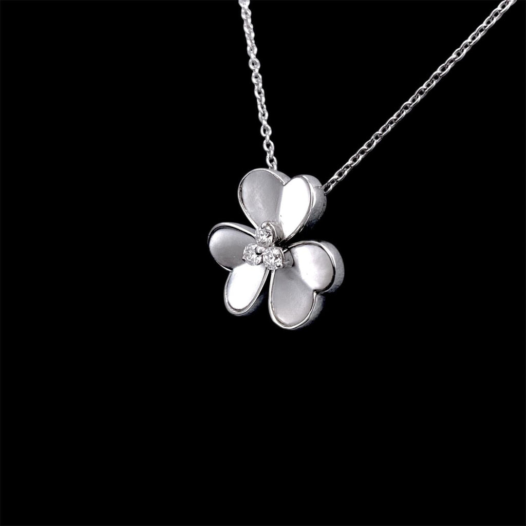 Impimo mother of pearl and moissanite flower pendant necklace - pendant and chain at a slight angle, cream shell petals against the white metal setting.