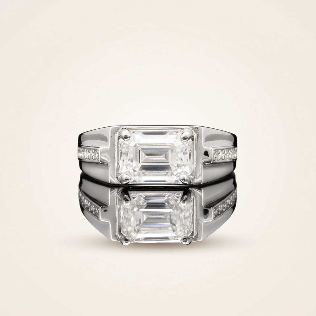 Moissanite emerald cut ring in 925 sterling silver with 18K white gold plating, on a light ivory background