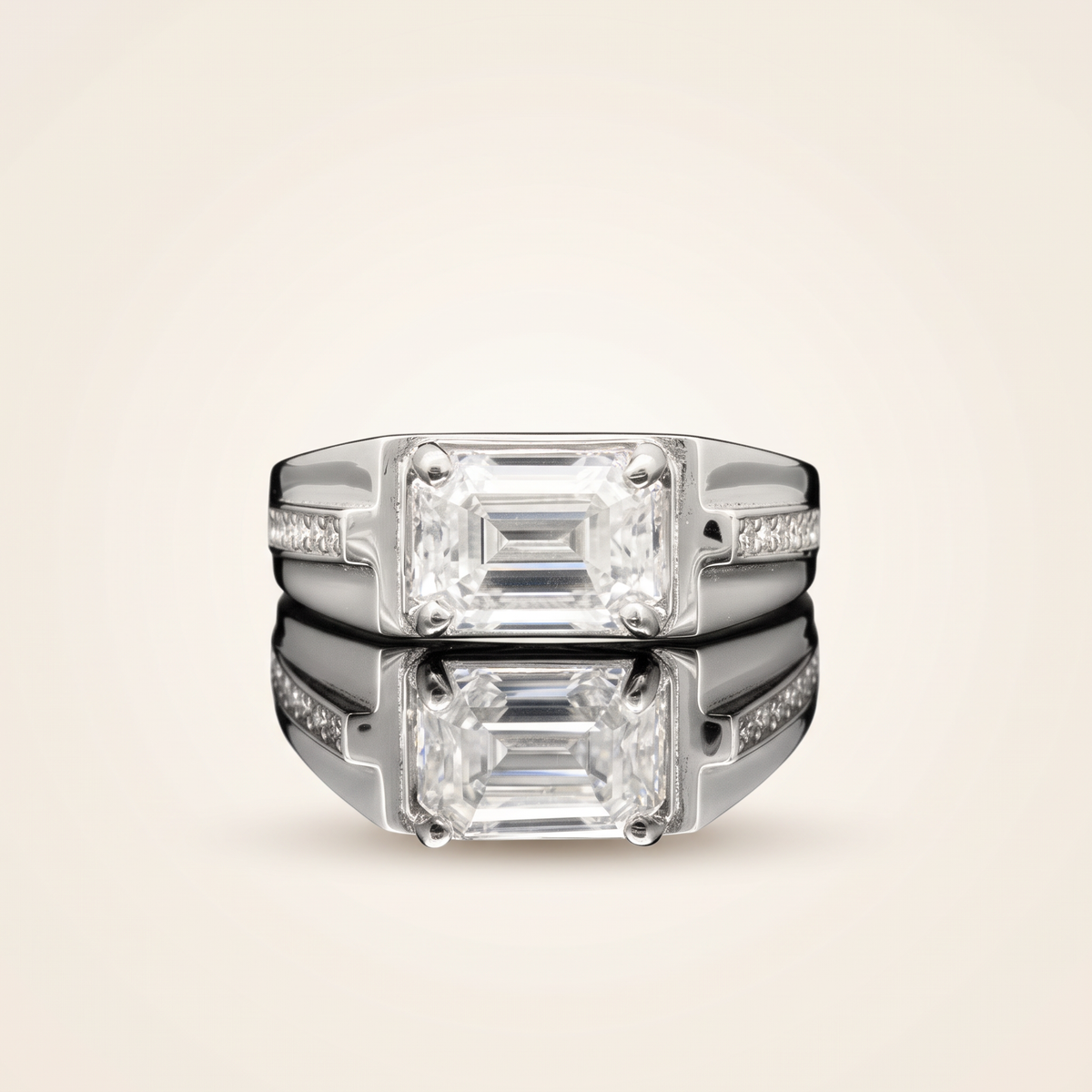 Moissanite emerald cut ring in 925 sterling silver with 18K white gold plating, on a light ivory background