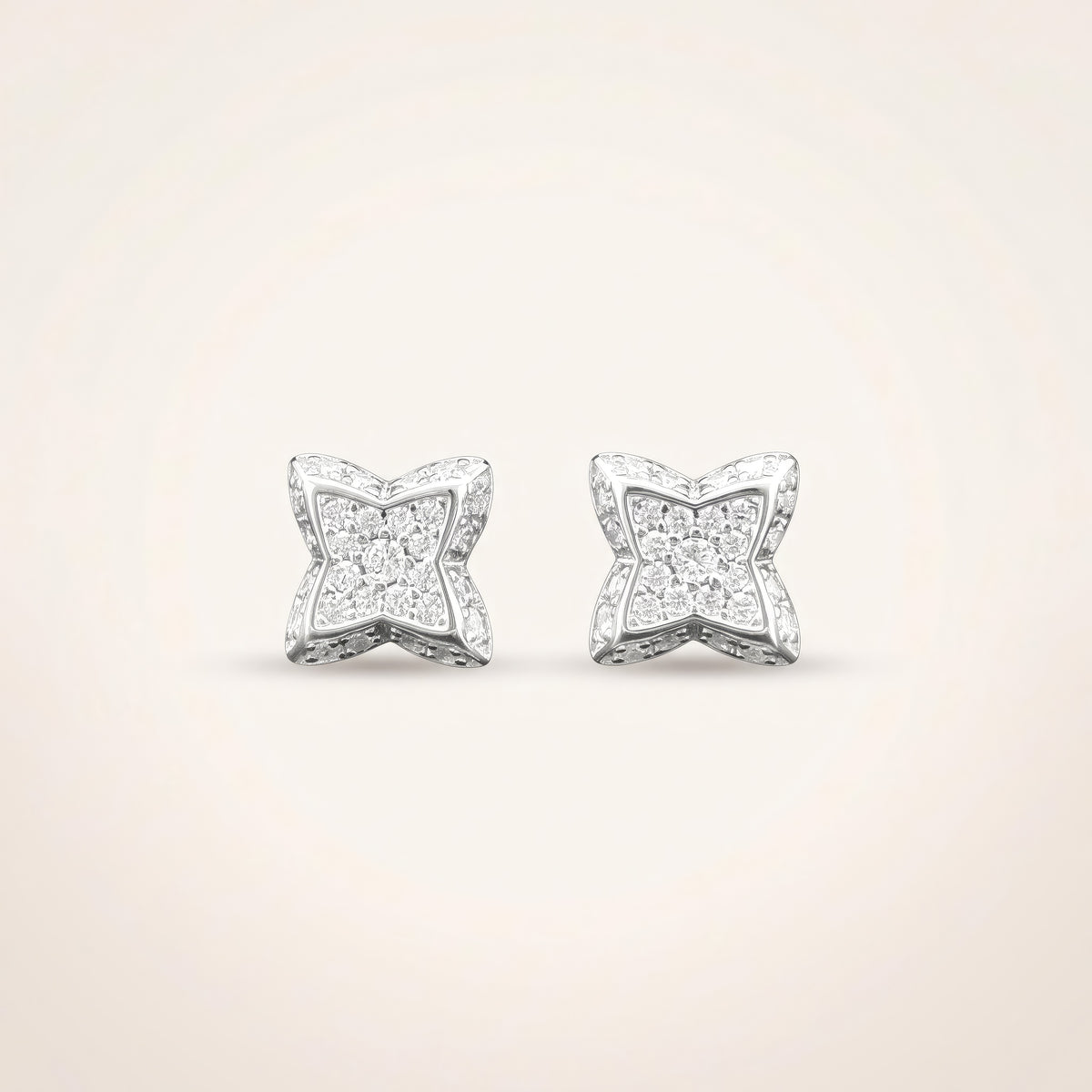 0.3 CT pair of moissanite round cut earrings in 925 sterling silver with 18K white gold plating, on a light ivory background