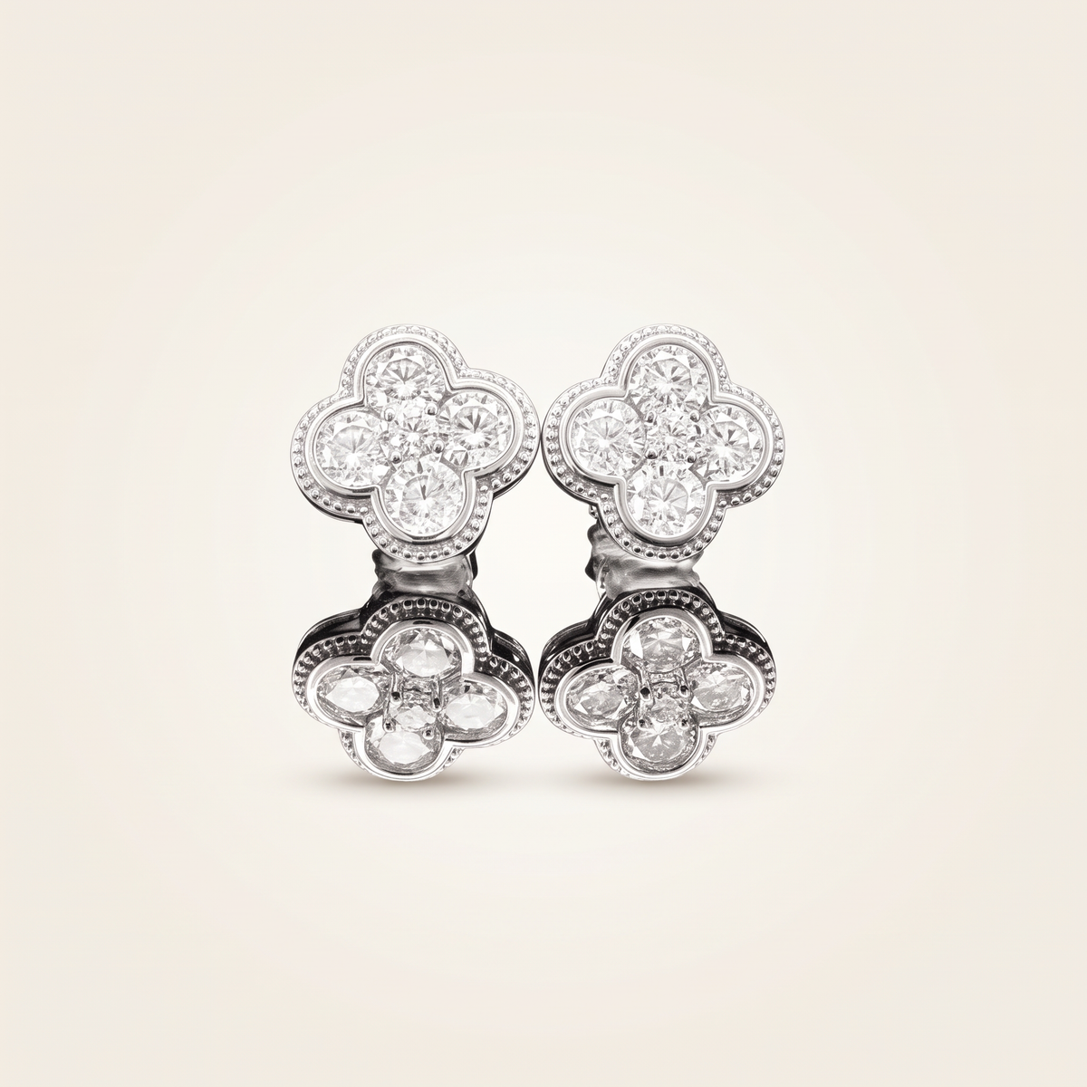 1.9 CT pair of moissanite round cut earrings in 925 sterling silver with 18K white gold plating, on a light ivory background