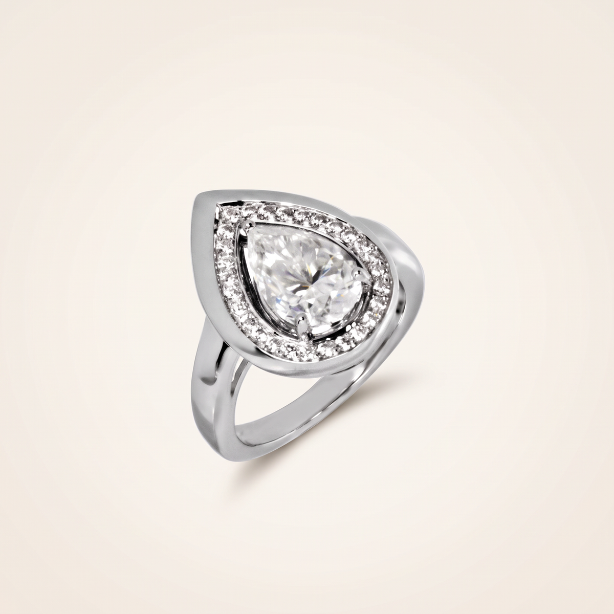 3 CT moissanite pear cut ring in 925 sterling silver with 18K white gold plating, on a light ivory background