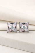 Impimo Natural Pink Mother of Pearl & Moissanite Four-Point Star Stud Earrings - 925 Sterling Silver with 18K White Gold Plating | display view on ivory linen