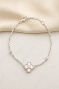 Impimo Natural Pink Mother of Pearl & Moissanite Four-Leaf Clover Bracelet - 925 Sterling Silver with 18K White Gold Plating | display view on ivory linen