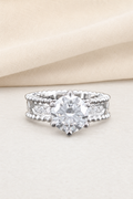 Impimo 1/2 CT Moissanite Round Solitaire Ring - Perlée Band - 925 Sterling Silver with 18K White Gold Plating | display view on ivory linen