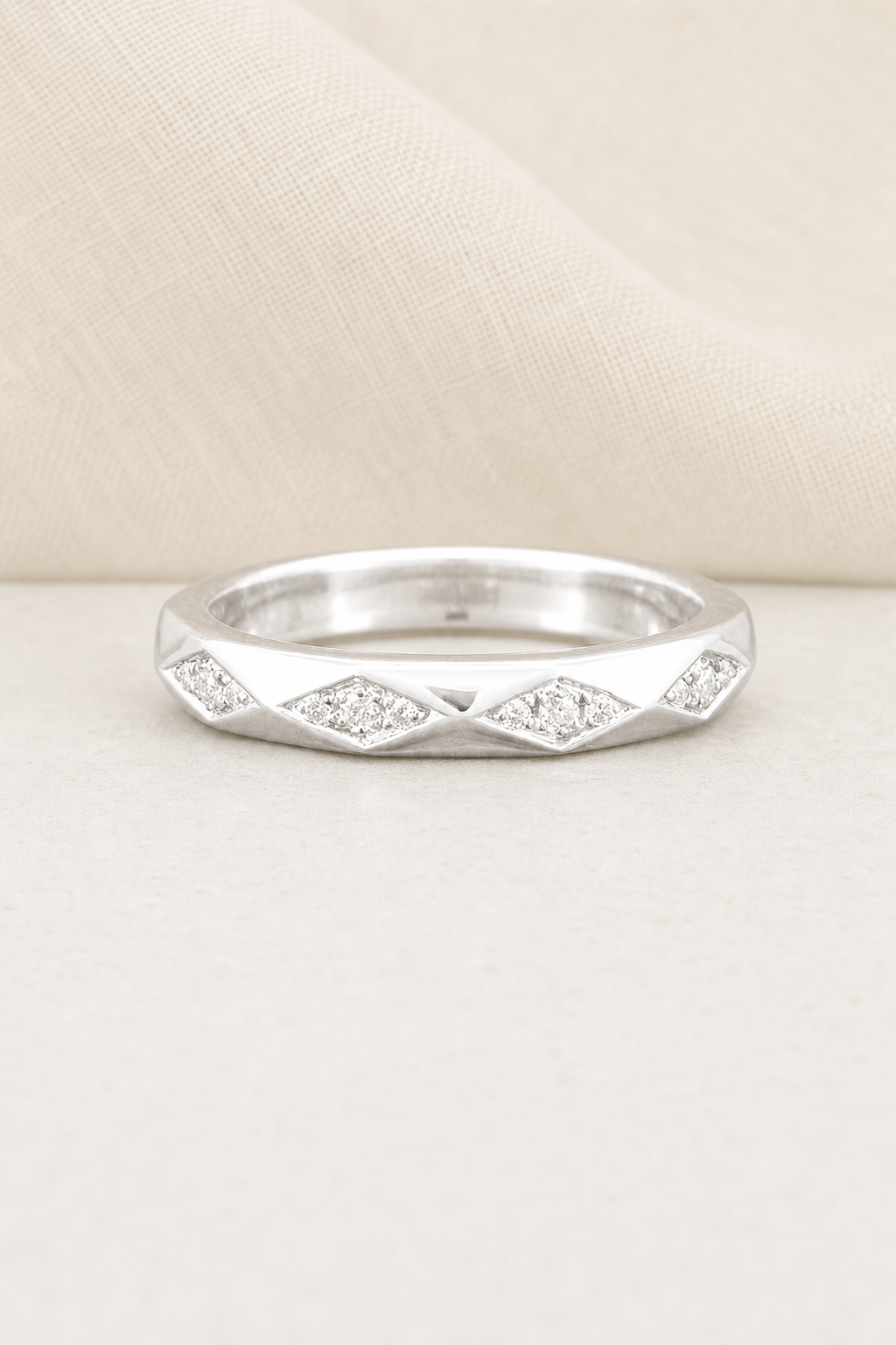 Impimo 0.35 CT Moissanite Round Eternity Ring - 925 Sterling Silver 18K White Gold | display view on ivory linen