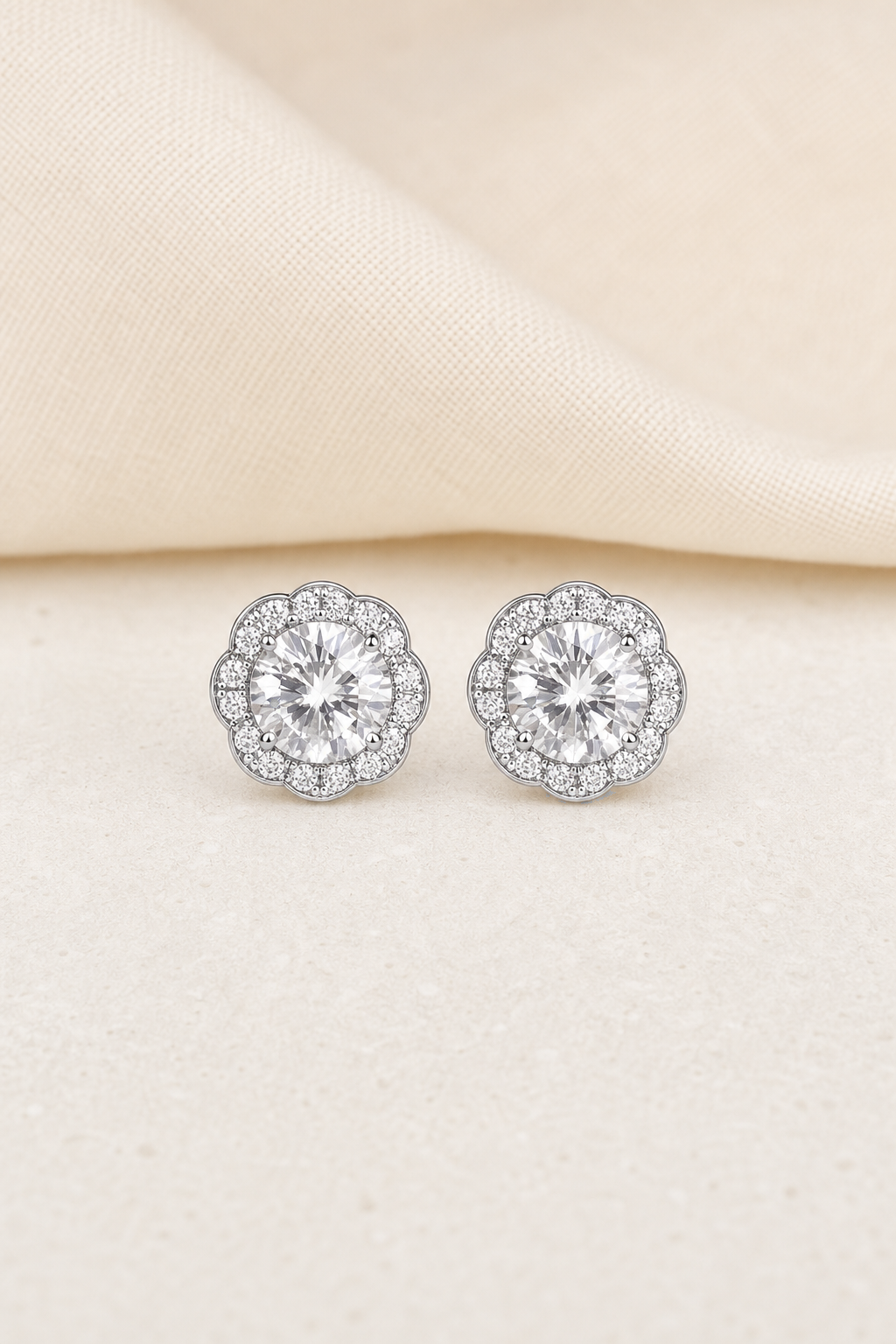 Impimo 2.3 CT (Total) Moissanite Round Cut Earrings - 925 Sterling Silver with 18K White Gold Plating | display view on ivory linen