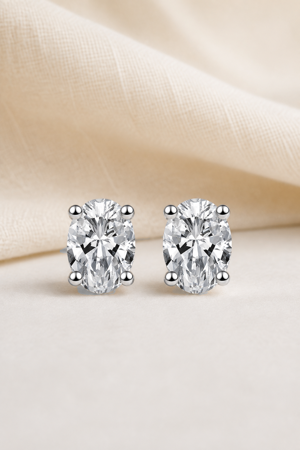 Impimo 1/2/4 CT Moissanite Oval Cut Earrings - 925 Sterling Silver with 18K White Gold Plating | display view on ivory linen
