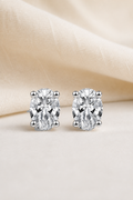 Impimo 1/2/4 CT Moissanite Oval Cut Earrings - 925 Sterling Silver with 18K White Gold Plating | display view on ivory linen