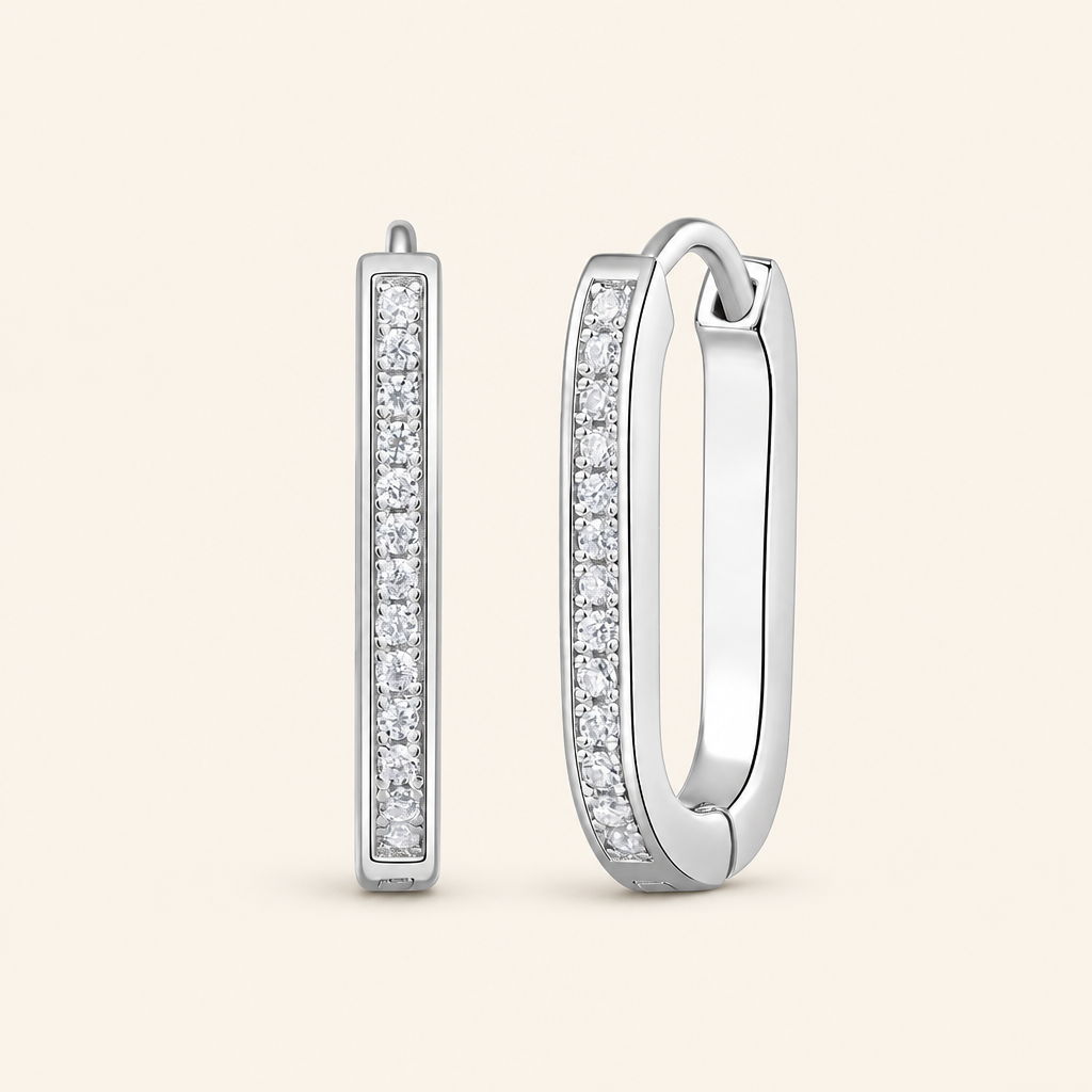 Impimo 0.15 CT (Total) Moissanite Round Cut Earrings - Elongated Pavé Huggie Hoop - 925 Sterling Silver with 18K White Gold Plating | packshot on ivory