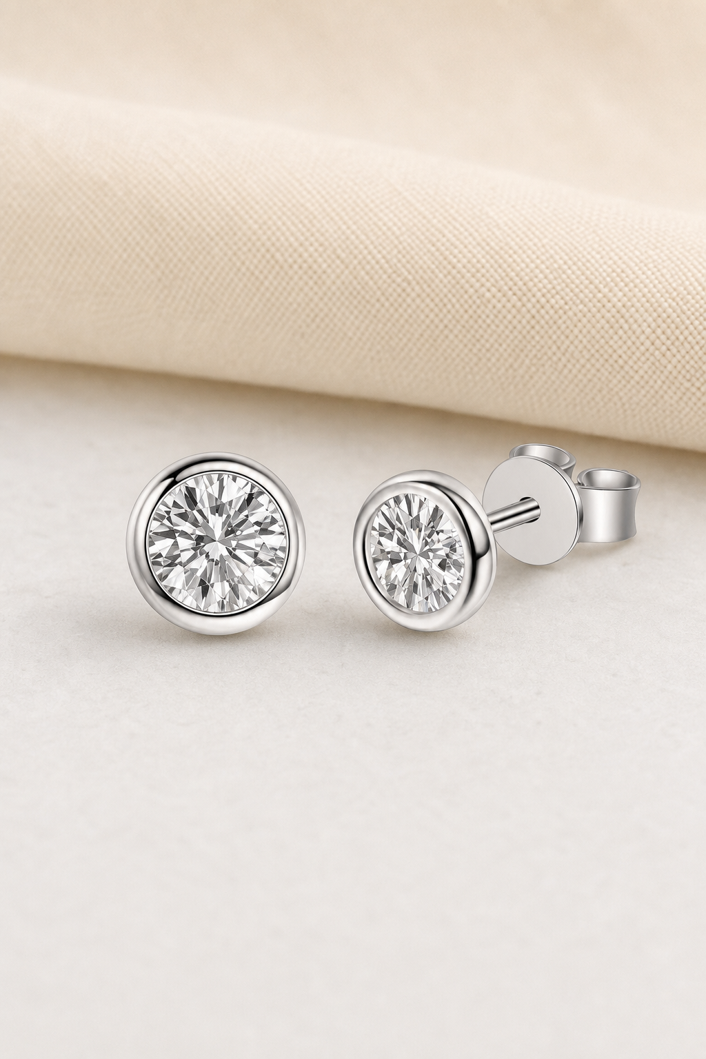 Impimo 0.6/1/2 CT Moissanite Round Cut Earrings - 925 Sterling Silver with 18K White Gold Plating | display view on ivory linen