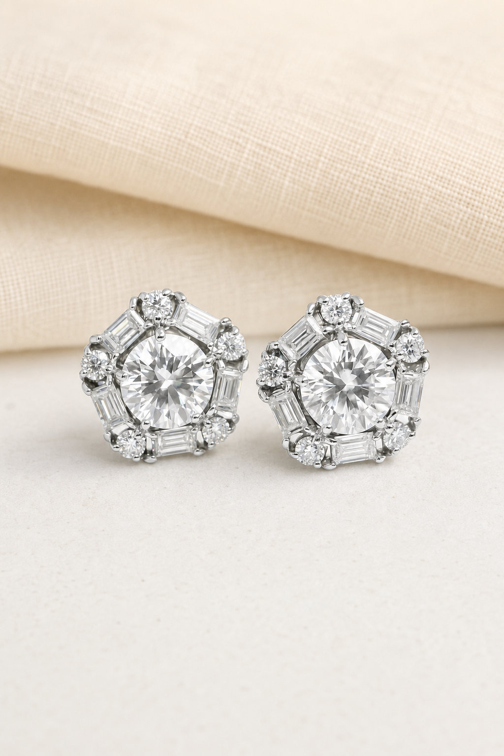 Impimo Moissanite Round Cut Earrings - 925 Sterling Silver with 18K White Gold Plating | display view on ivory linen