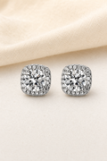 Impimo 1/2 CT (Pair) Moissanite Round Cut Earrings - Cushion Halo Stud - 925 Sterling Silver with 18K White Gold Plating | display view on ivory linen