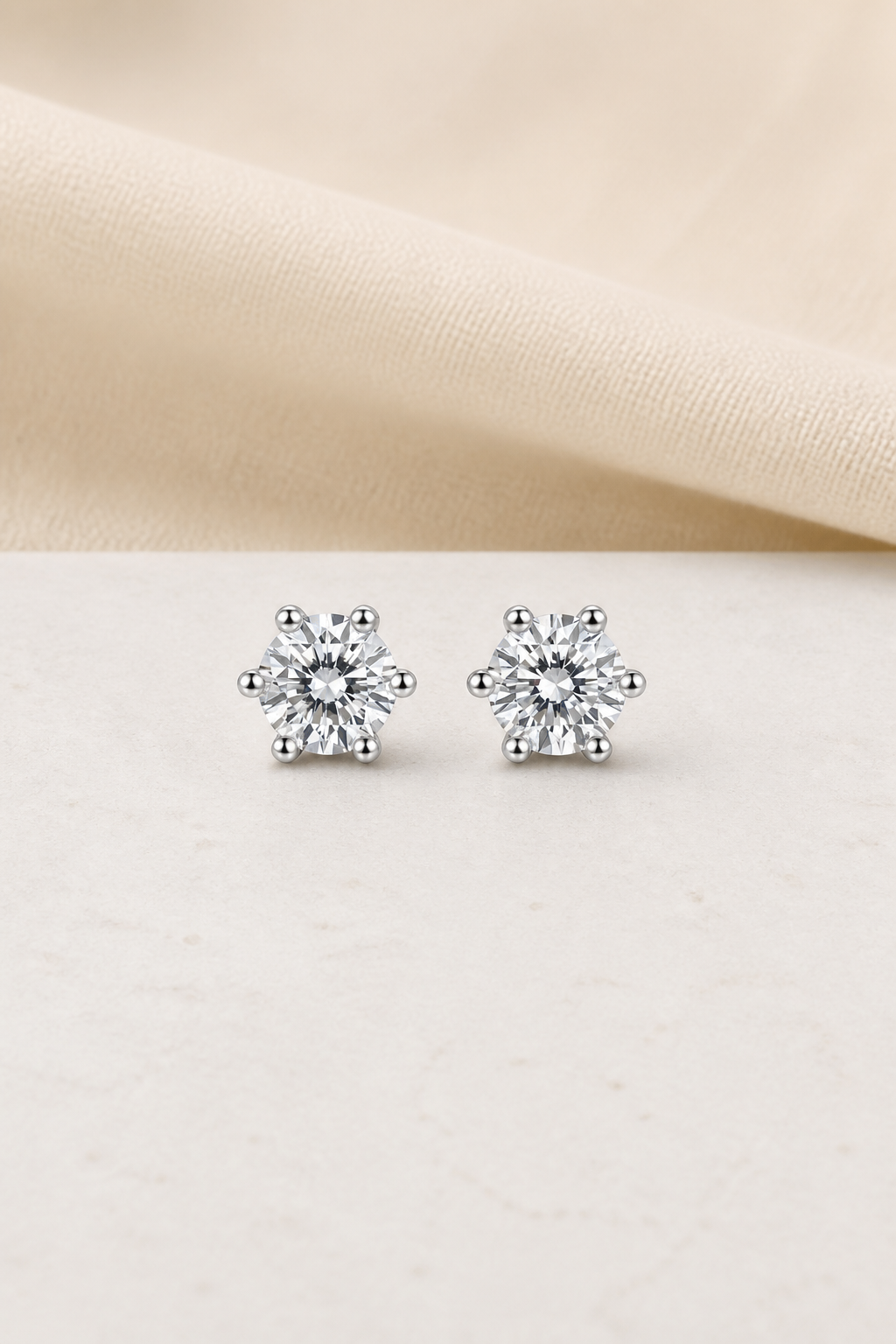 Impimo 0.6/1/2/4/6 CT (Pair) Moissanite Round Cut Earrings - 925 Sterling Silver with 18K White Gold Plating | display view on ivory linen