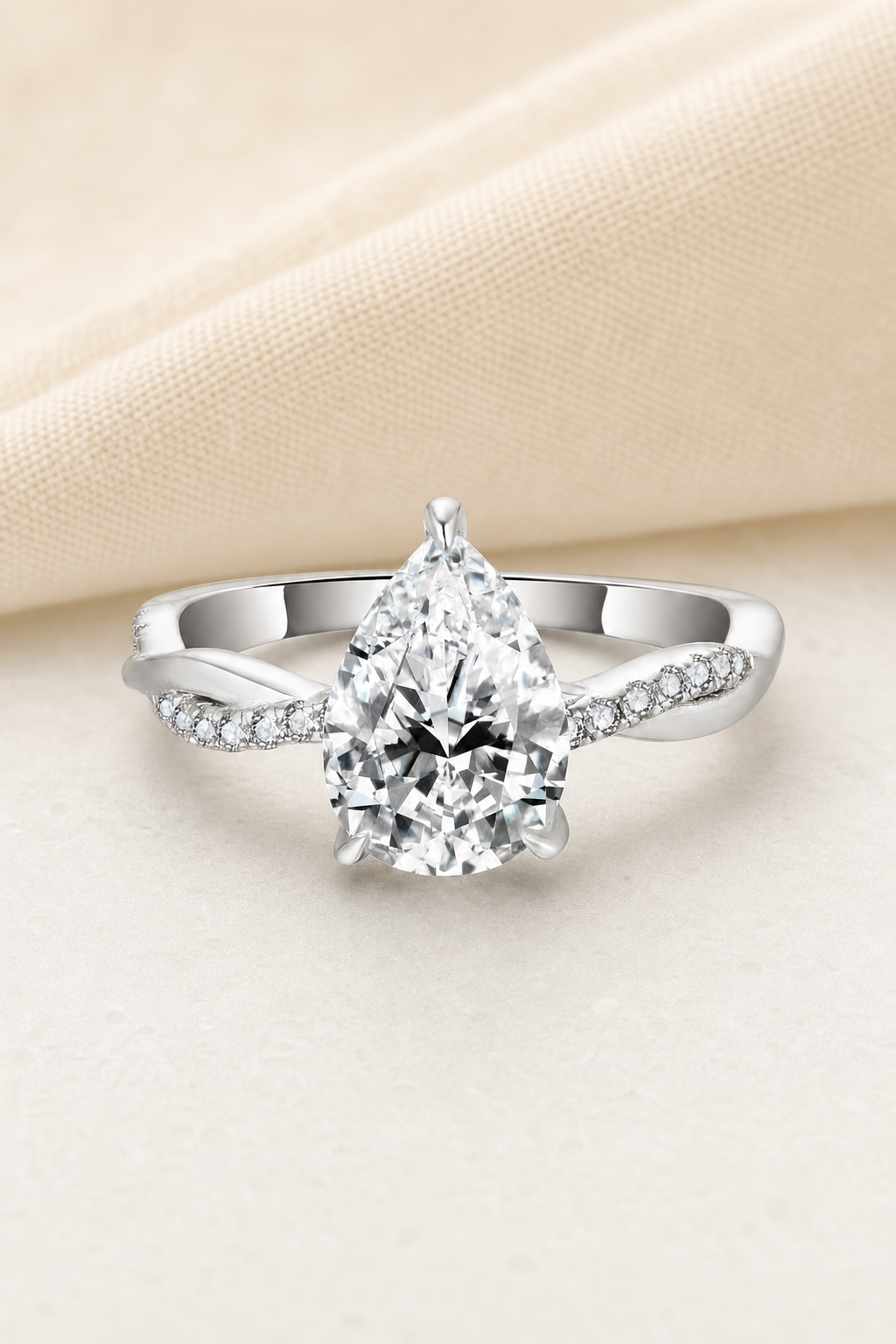 Impimo 2 CT Moissanite Multiple Shape Ring - 925 Sterling Silver with 18K White Gold Plating | display view on ivory linen - pear cut