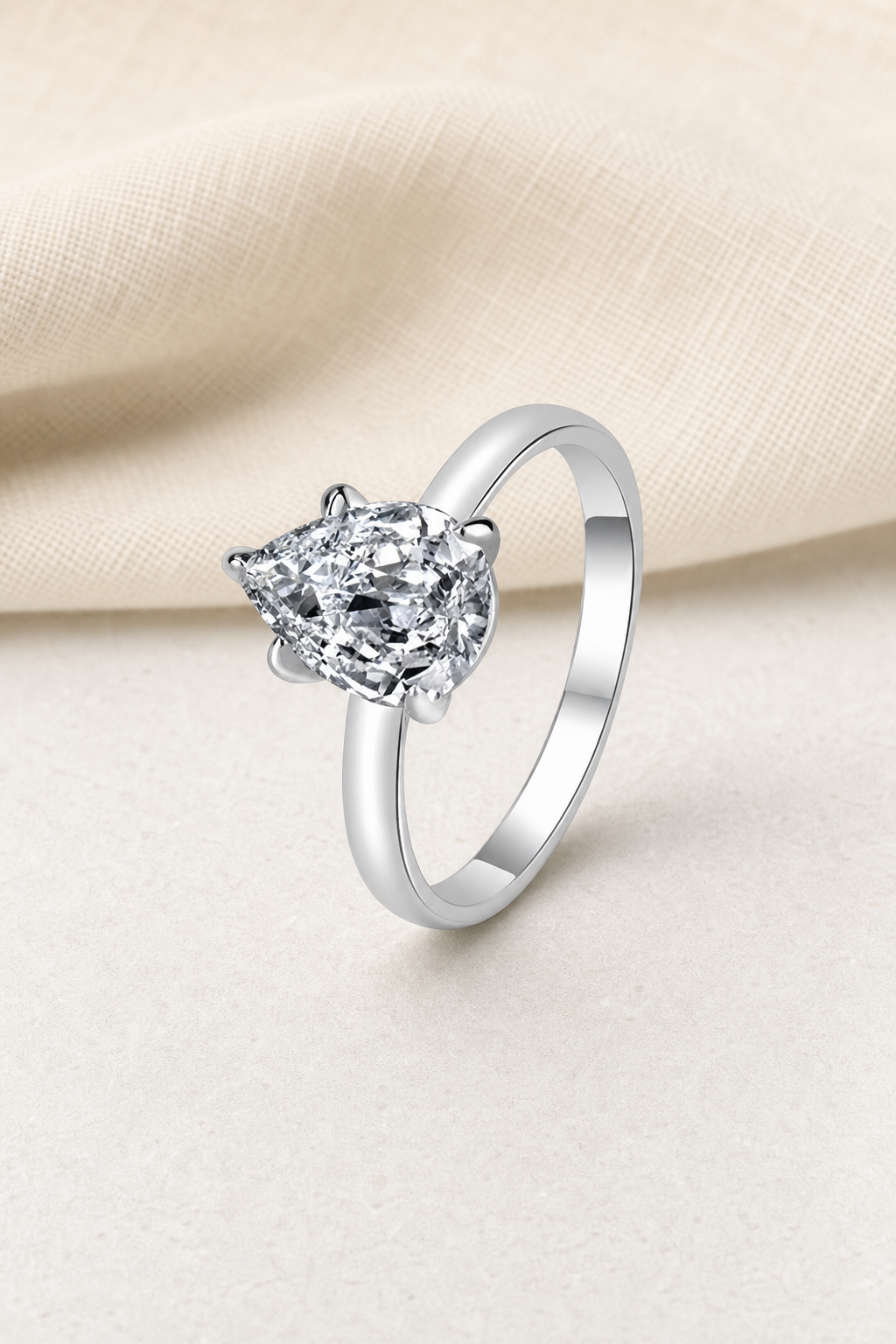 Impimo 1/2 CT Lab-Grown Diamond Ring - Radiant, Oval, Marquise & Pear Cut Options - 925 Sterling Silver with 18K White Gold Plating | display view on ivory linen - pear cut