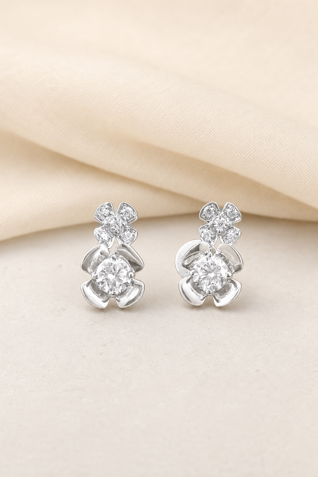 Impimo Moissanite Floral Stud Earrings - 0.6 CT Total (0.3 CT Each) - 925 Silver 18K White Gold | display view on ivory linen