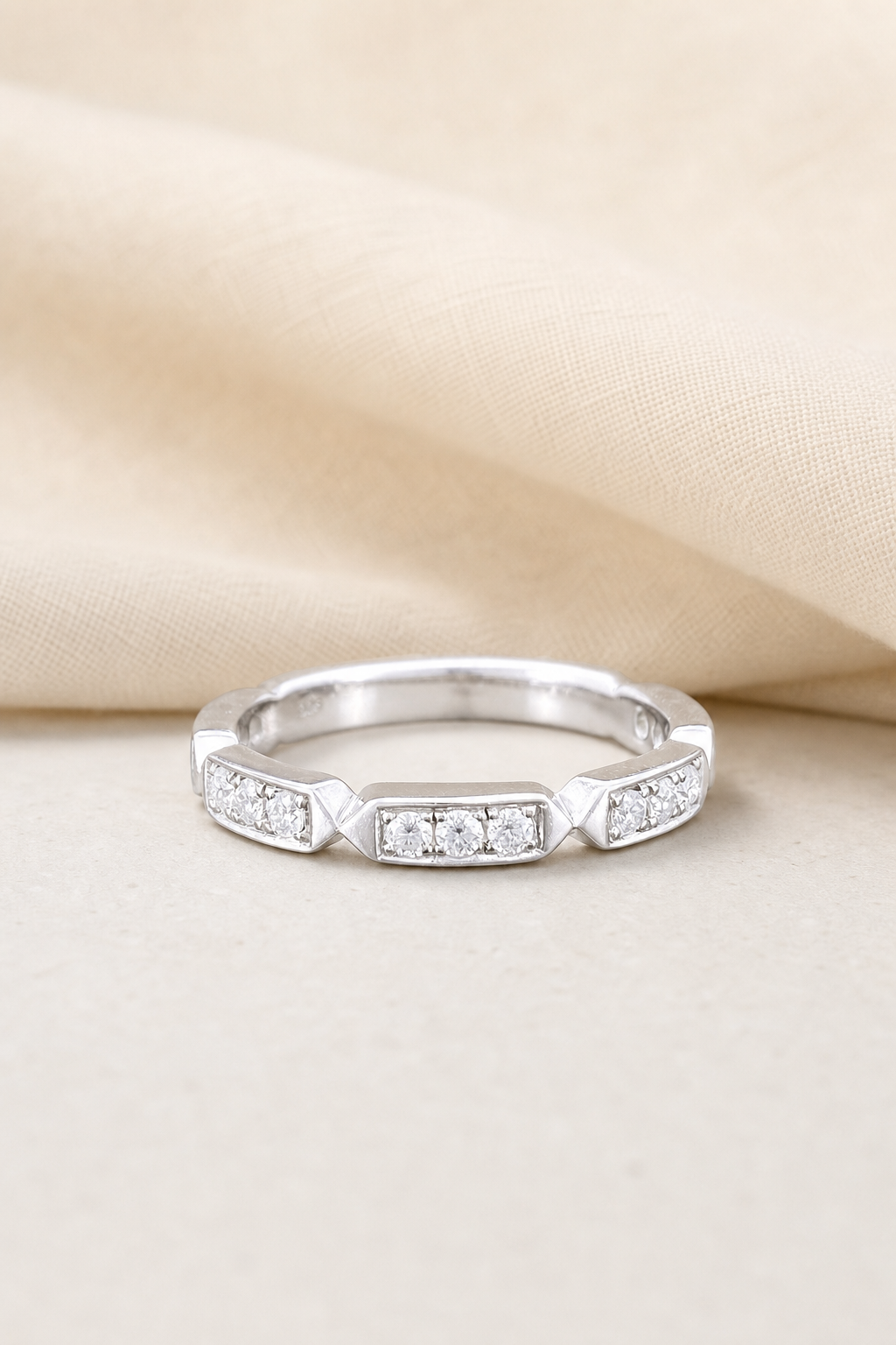 Impimo Moissanite Half Eternity Ring - 0.3 CT Total - 925 Silver 18K White Gold | display view on ivory linen