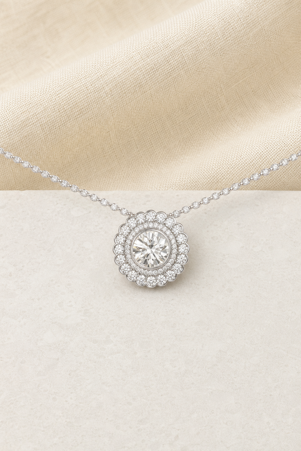 Impimo Moissanite Round Cut Pendant 2ct and 0.9ct - 925 Sterling Silver with 18K White Gold Plating | display view on ivory linen