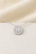 Impimo Moissanite Round Cut Pendant 2ct and 0.9ct - 925 Sterling Silver with 18K White Gold Plating | display view on ivory linen