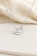 Impimo 0.5 CT Moissanite Dual Floral Necklace - 925 Silver 18K White Gold | display view on ivory linen