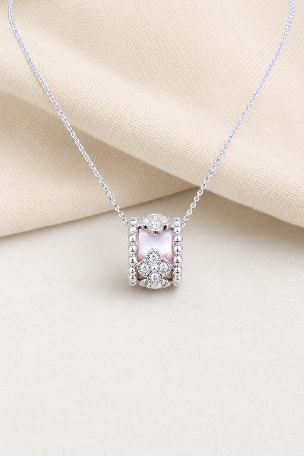 Impimo Natural Pink Mother of Pearl & Moissanite Flower Motif Slider Pendant - 925 Sterling Silver with 18K White Gold Plating | display view on ivory linen