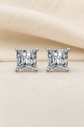 Impimo Moissanite Princess Cut Earrings - 925 Sterling Silver with 18K White Gold Plating | display view on ivory linen