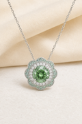 Impimo 2.55 CT Fancy Green Moissanite Pendant - Flower Design - 925 Sterling Silver with 18K White Gold Plating | display view on ivory linen