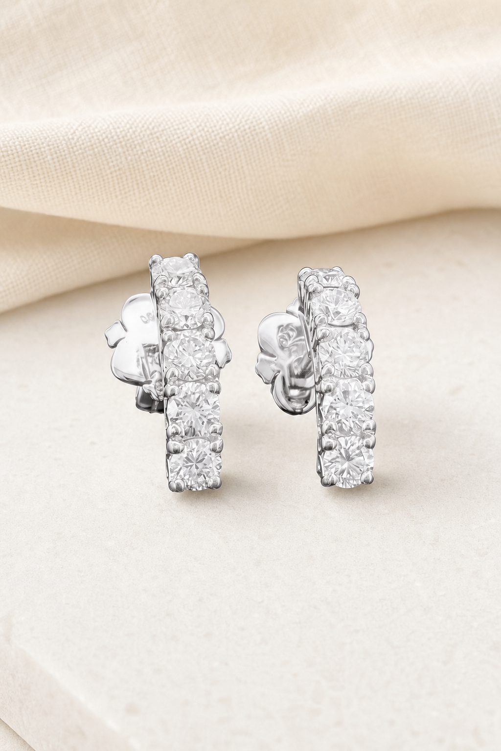 Impimo 1.1 CT (Pair) Lab-Grown Diamond Round Cut Earrings - 925 Sterling Silver with 18K White Gold Plating | display view on ivory linen