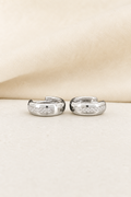 Impimo 0.2 CT (Pair) Moissanite Round Cut Earrings - 925 Sterling Silver with 18K White Gold Plating | display view on ivory linen