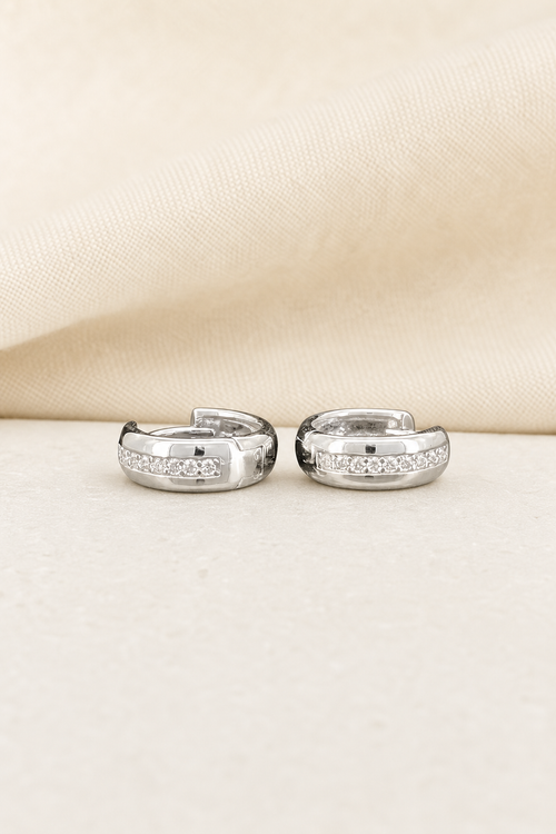 Impimo 0.2 CT (Pair) Moissanite Round Cut Earrings - 925 Sterling Silver with 18K White Gold Plating | display view on ivory linen