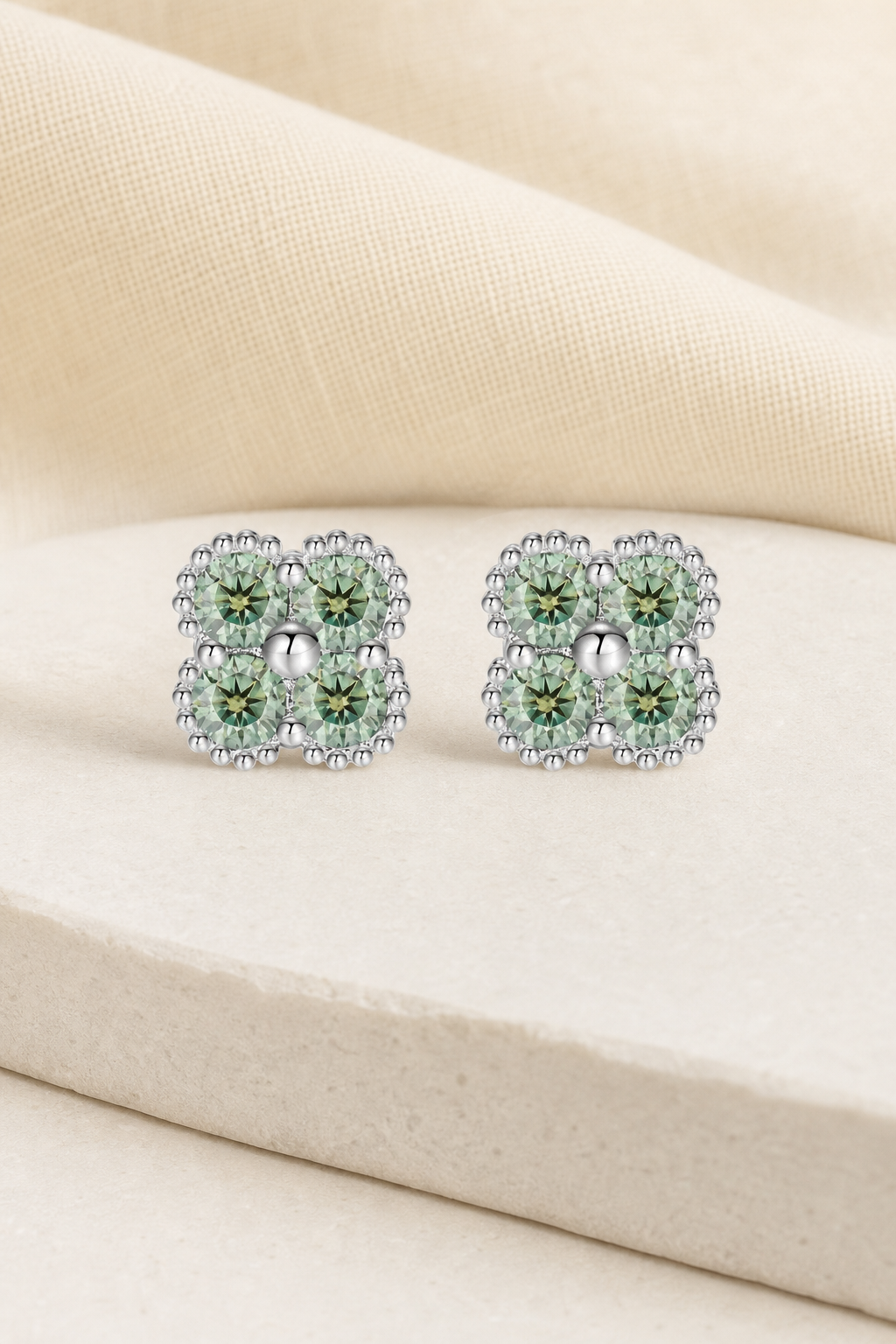 Impimo Fancy Green Moissanite Four-Leaf Clover Jewelry Set - Pendant, Bracelet & Earrings | display view on ivory linen