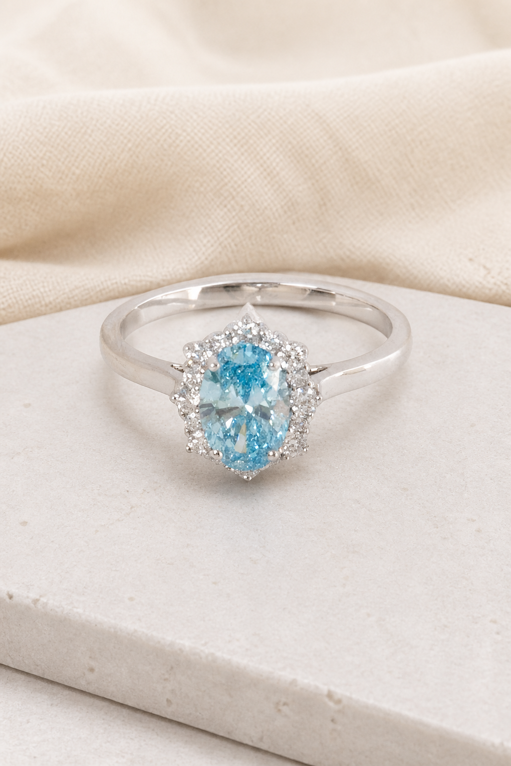Impimo 1.27 CT Fancy Vivid Blue Lab-Grown Diamond Oval Cut Ring - 9K White Gold | display view on ivory linen