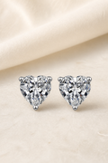 Impimo 1/2/4 CT Moissanite Heart Cut Earrings - 925 Sterling Silver with 18K White Gold Plating | display view on ivory linen