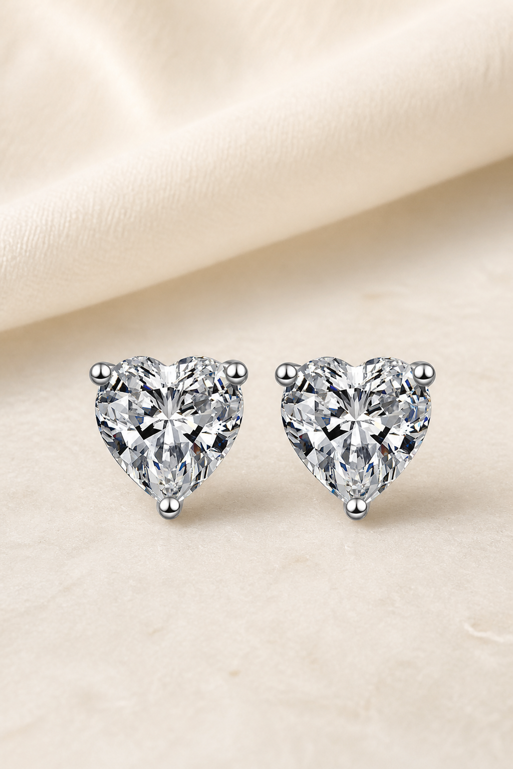 Impimo 1/2/4 CT Moissanite Heart Cut Earrings - 925 Sterling Silver with 18K White Gold Plating | display view on ivory linen