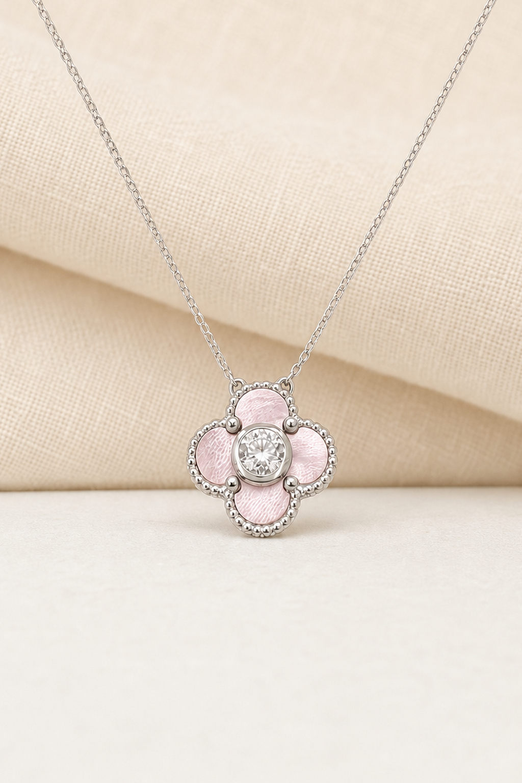 Impimo Natural Pink Mother of Pearl & Moissanite Four-Leaf Clover Pendant - 925 Sterling Silver with 18K White Gold Plating | close-up detail of the setting
