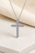 Impimo 1.1/1.6 CT (Total) Moissanite Round Cut Cross Pendant - 925 Sterling Silver with 18K White Gold Plating | display view on ivory linen