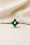 Impimo Natural Malachite & Moissanite Pendant - Four-Point Star - 925 Sterling Silver with 18K White Gold Plating | display view on ivory linen
