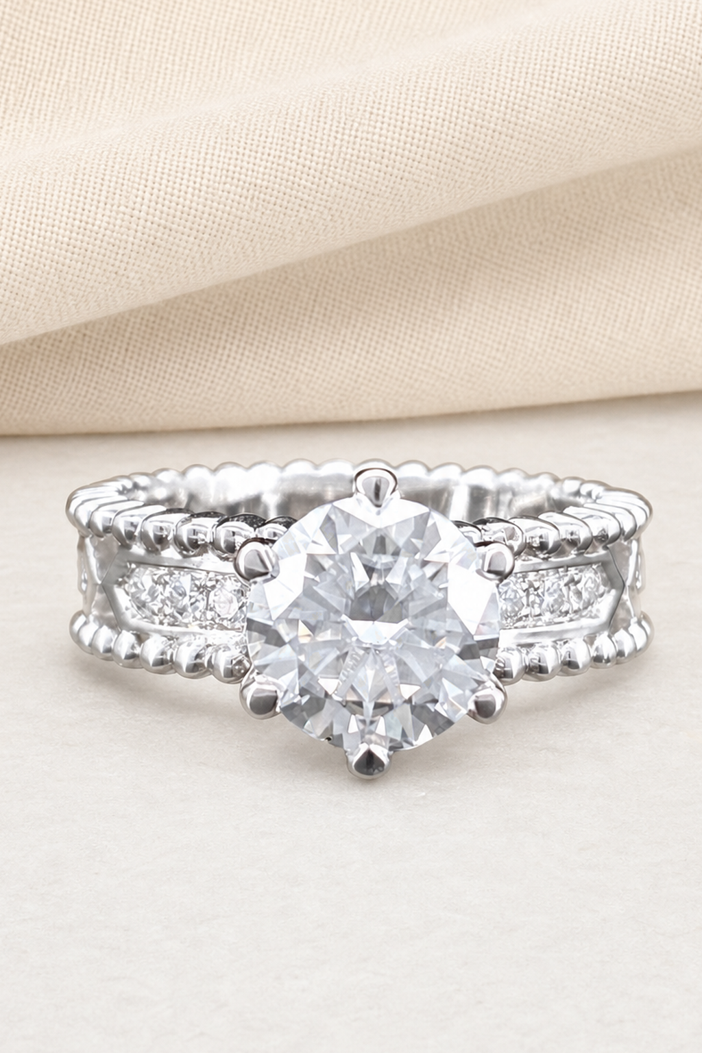 Impimo 1/2 CT Moissanite Round Solitaire Ring - Perlée Band - 925 Sterling Silver with 18K White Gold Plating | close-up detail of the setting