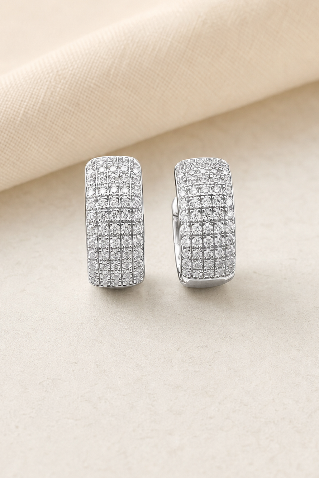 Impimo 0.6 CT (Pair) Moissanite Round Cut Earrings - Pavé Cylinder Huggie Hoop - 925 Sterling Silver with 18K White Gold Plating | close-up detail of the setting