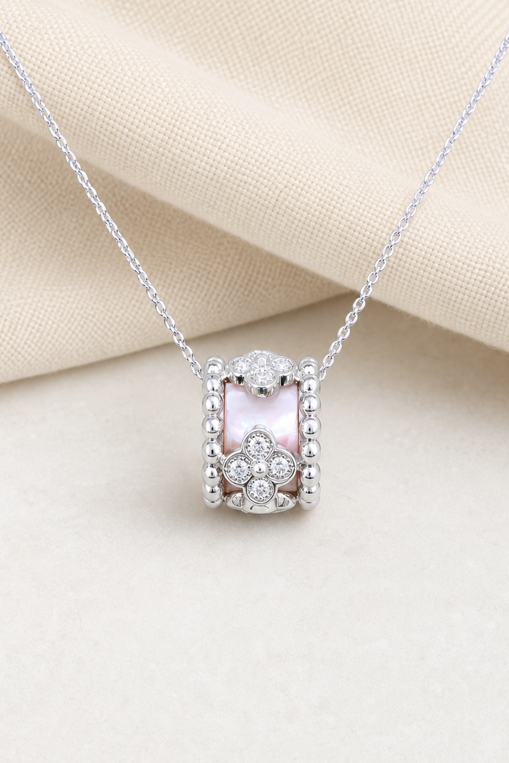 Impimo Natural Pink Mother of Pearl & Moissanite Flower Motif Slider Pendant - 925 Sterling Silver with 18K White Gold Plating | close-up detail of the setting