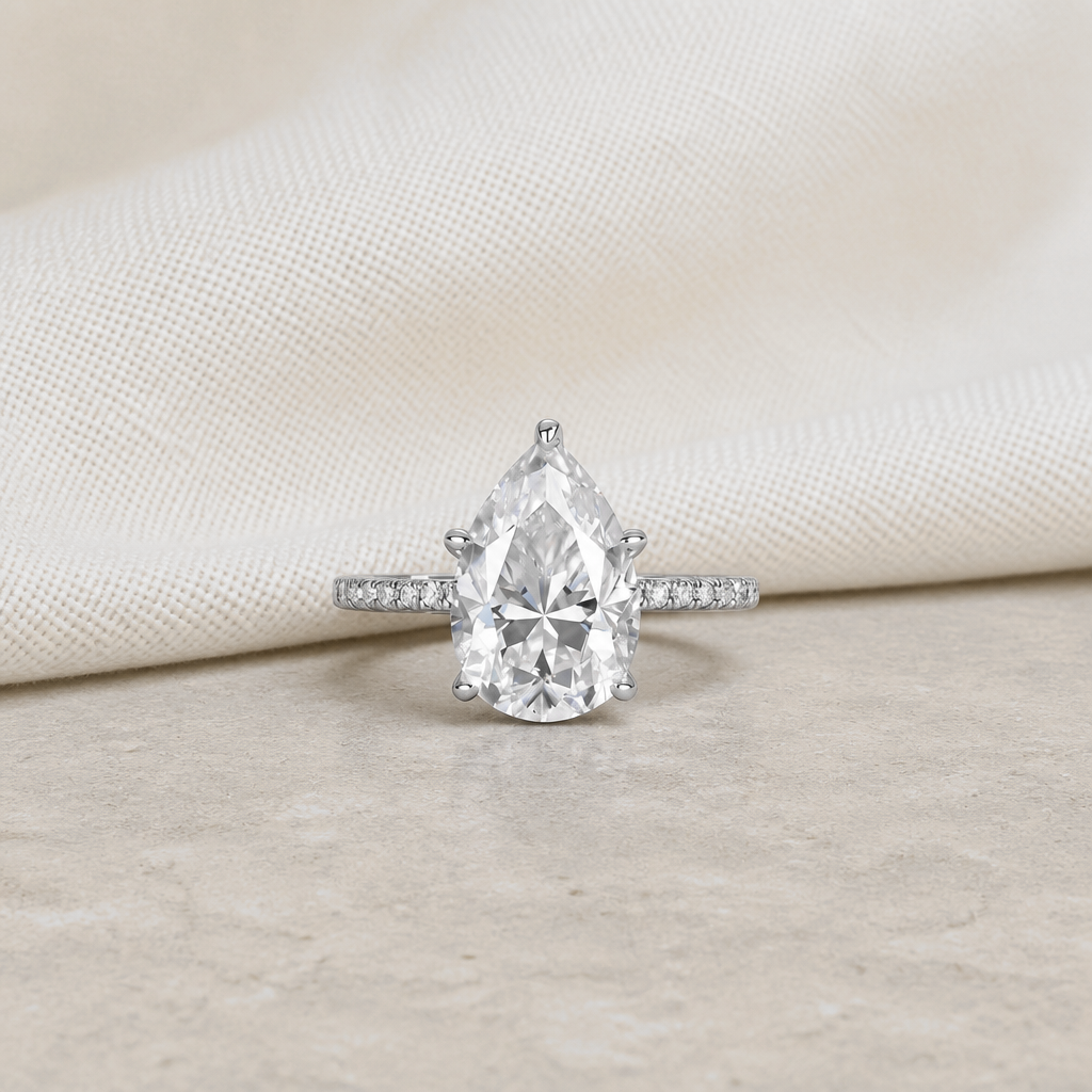 Impimo 4 CT Moissanite Pear Cut Ring - 925 Sterling Silver with 18K White Gold Plating | additional view on ivory linen