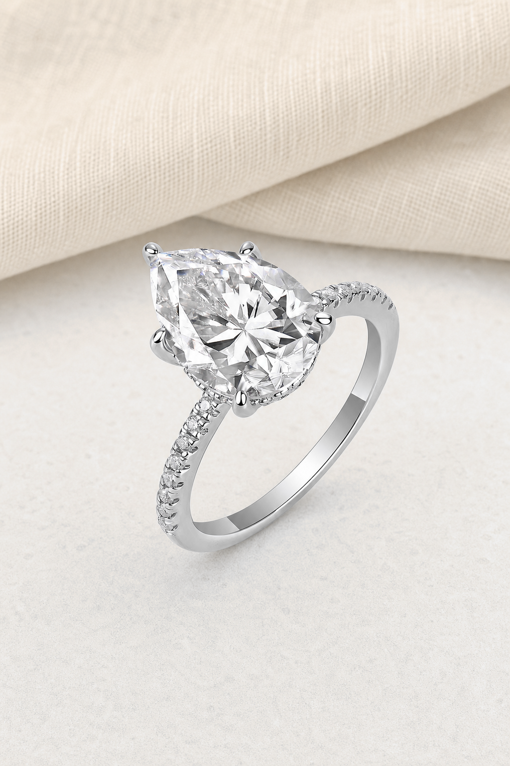 Impimo 4 CT Moissanite Pear Cut Ring - 925 Sterling Silver with 18K White Gold Plating | display view on ivory linen