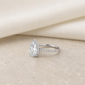 Impimo 4 CT Moissanite Pear Cut Ring - 925 Sterling Silver with 18K White Gold Plating | additional view on ivory linen