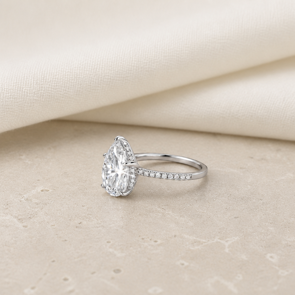 Impimo 4 CT Moissanite Pear Cut Ring - 925 Sterling Silver with 18K White Gold Plating | additional view on ivory linen