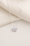 Impimo Natural Mother of Pearl & Moissanite Flower Pendant Necklace - 925 Sterling Silver with 18K White Gold Plating - display view on ivory linen