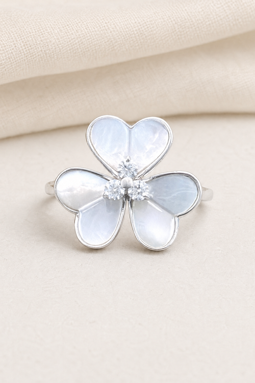 Impimo 0.15 CT Moissanite & Mother of Pearl Flower Ring - 925 Sterling Silver with 18K White Gold Plating - display view on ivory linen